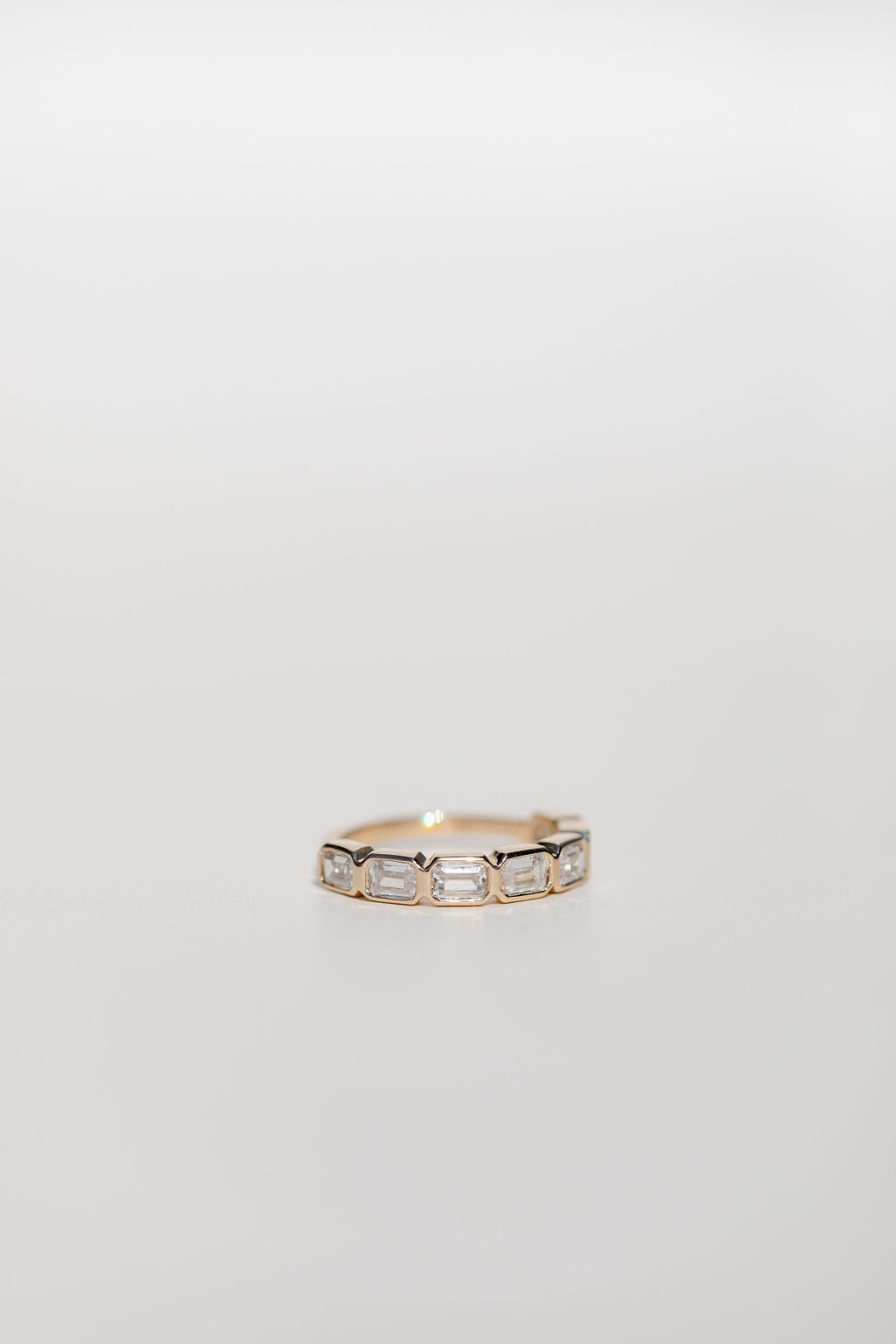 Bezel set emerald cut diamond statement wedding ring