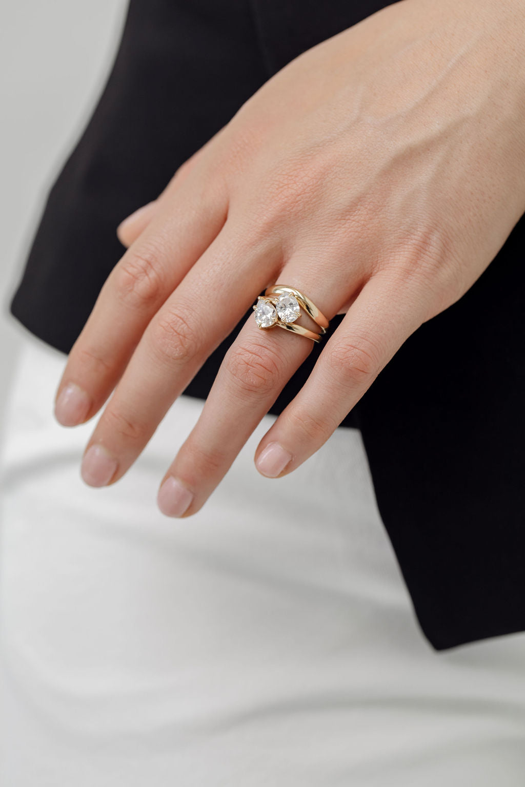 Bold curved wedding ring with toi et moi engagement ring