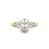 Three stone diamond engagement ring with oval cut diamond centre stone and pear cut diamond side stones