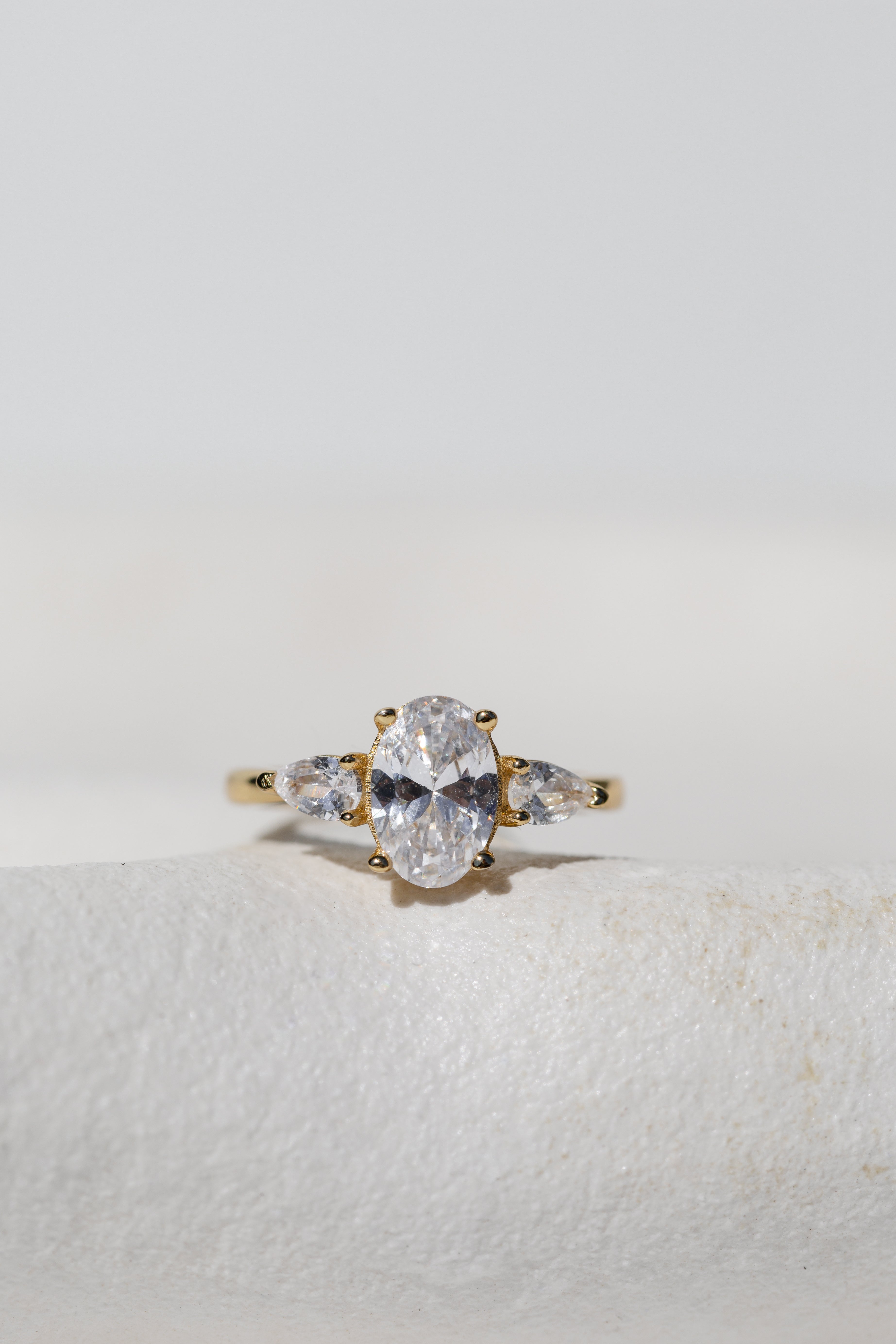 OVAL WITH PEAR SIDE STONES THREE STONE TRILOGY ENGAGEMENT RING
