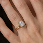 radiant cut diamond solitaire engagement ring with curved gold wedding ring
