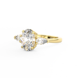 Three Stone Trilogy Diamond engagement ring with oval cut diamond centre stone and pear cut diamond side stones