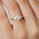 Three stone diamond engagement ring with marquise centre stone and half moon cut diamond side stones