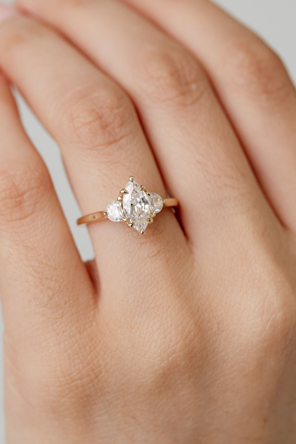 Three stone diamond engagement ring with marquise centre stone and half moon cut diamond side stones