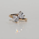 Toi et moi diamond engagement ring with oval cut diamond and pear cut diamond