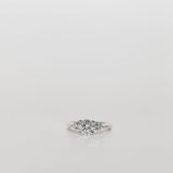 Trilogy Three stone ring with a round cut centre diamond and brilliant cut side stones