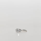 Trilogy engagement ring with a round cut diamond centre and brilliant cut side stones