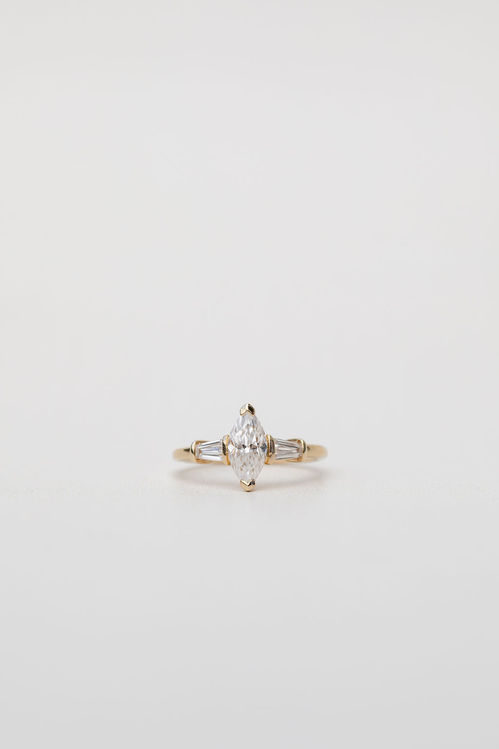 Trilogy three stone ring with marquise diamond centre