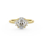 Oval Engagement ring with diamond halo featuring graduating diamonds in a yellow gold band