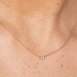 model wearing yellow gold baguette cut diamond pendant