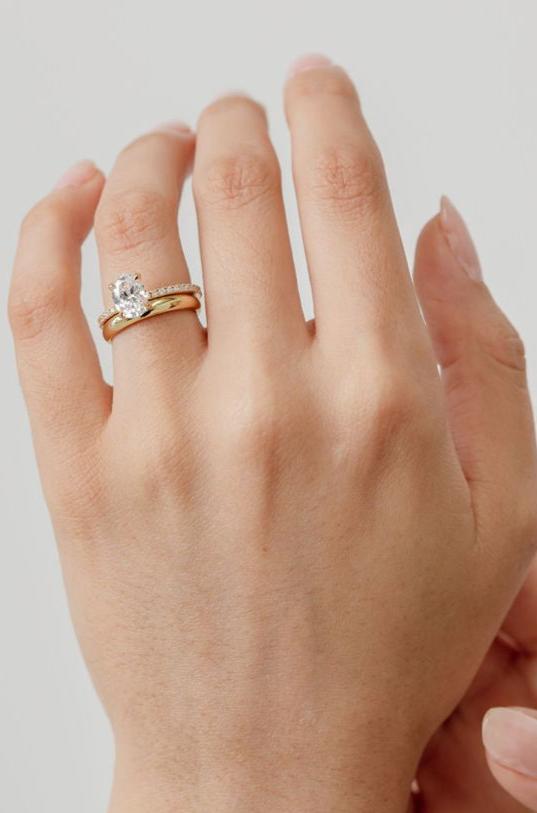 chunky gold wedding ring with oval engagement ring