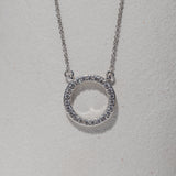 circle pendant with a halo of diamonds