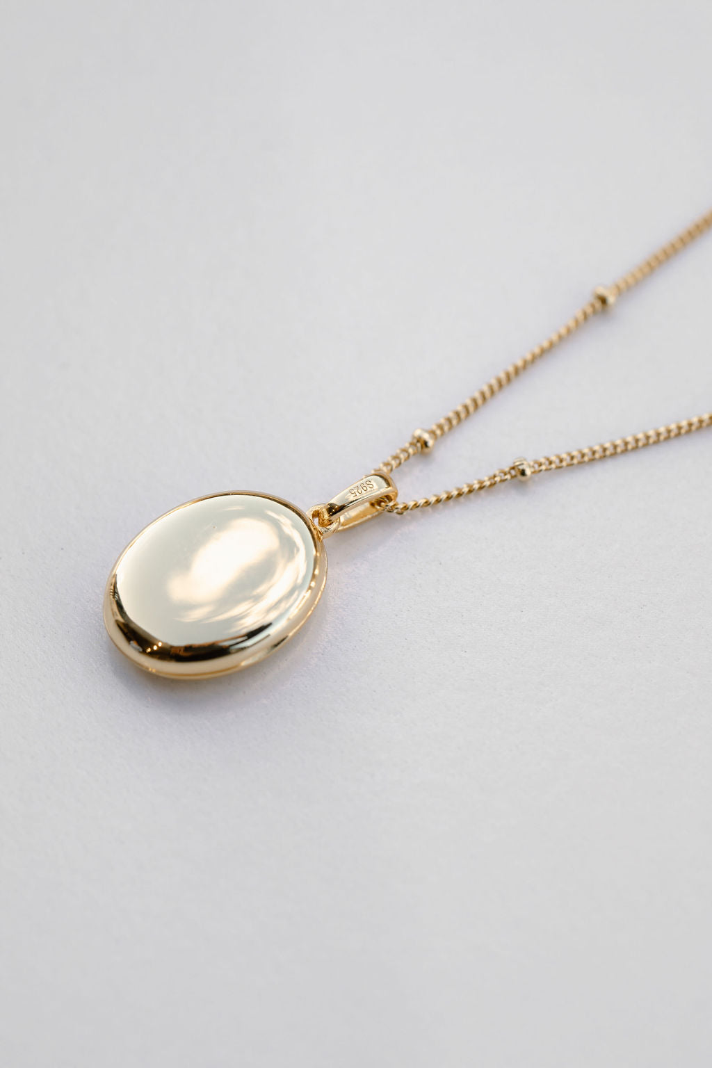gold oval locket on bead chain necklace