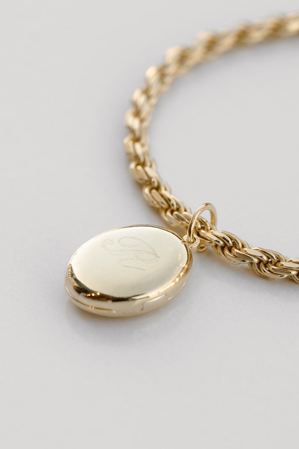 gold oval locket engraved with rope chain necklace