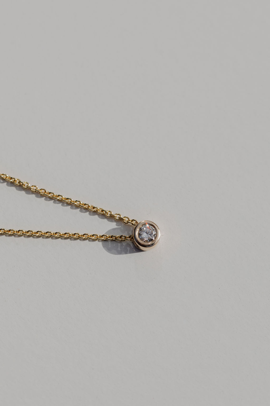 diamond bezel set necklace in gold