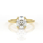 Double claw oval solitaire engagement ring in yellow gold