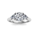 white gold 3 stone trilogy moissanite engagement ring with a round centre moissanite and trilliant cut moissanite side stones