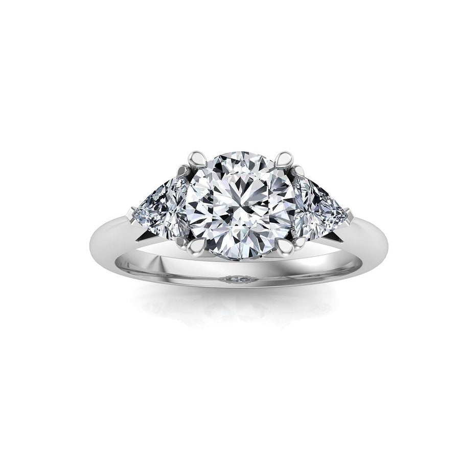 white gold 3 stone trilogy moissanite engagement ring with a round centre moissanite and trilliant cut moissanite side stones