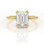 Emerald cut moissanite double claw engagement ring