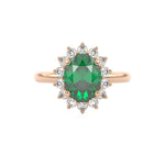 Emerald engagement ring with diamond halo