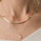 gold herringbone necklace and pearl pendant necklace