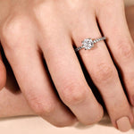 white gold engagement ring with round diamond centre and 4 claws on a diamond band