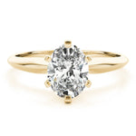 Yellow gold tapered solitaire engagement ring with oval moissanite