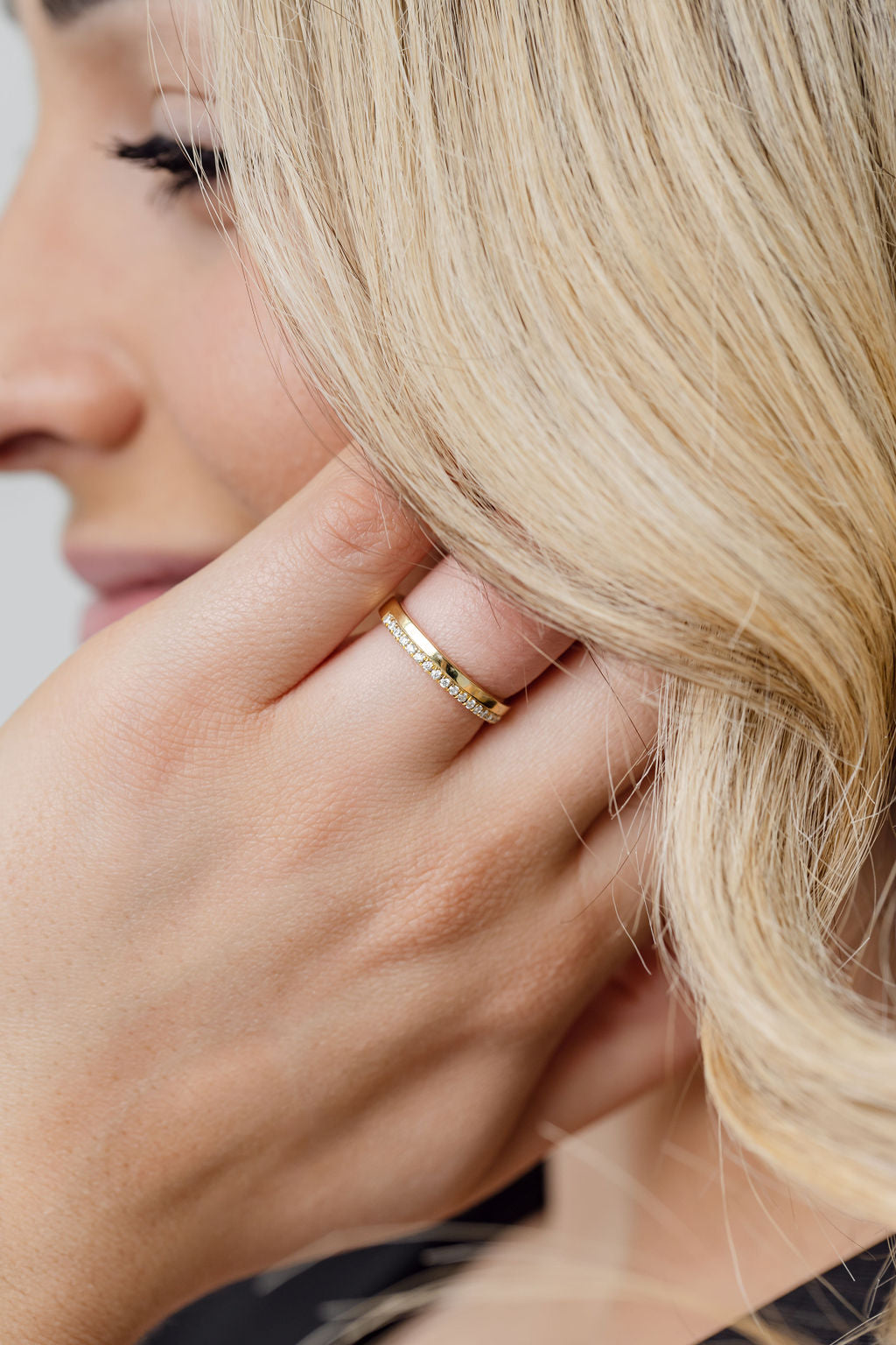 model wearing gold and diamond wedding ring