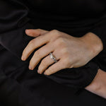 white gold diamond engagement ring with round diamond in the centre on 4 claws with a claw set diamond band and a diamond wedding ring with single claw