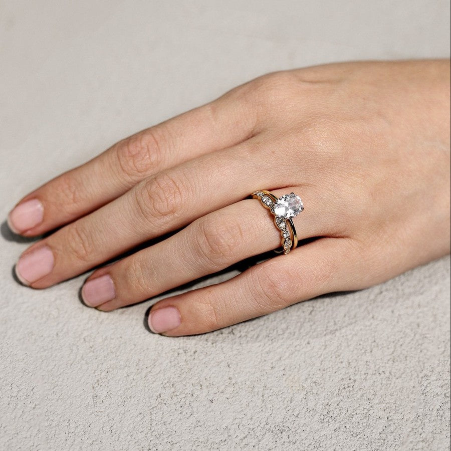 yellow gold oval diamond solitaire engagement ring and yellow gold diamond wedding ring