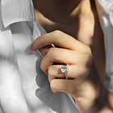 yellow gold oval solitaire engagement ring with oval set east west and a diamond wedding ring