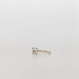 oval diamond cut engagement ring with pave set diamond band in yellow gold