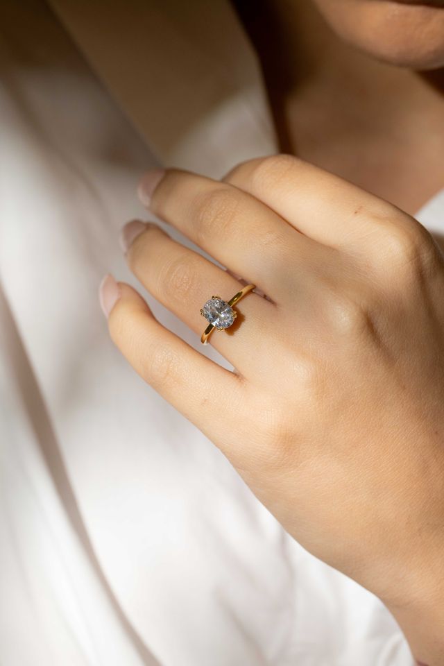 oval solitaire with double claw with gold