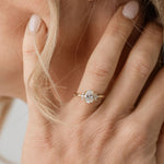Oval engagement ring with side stones