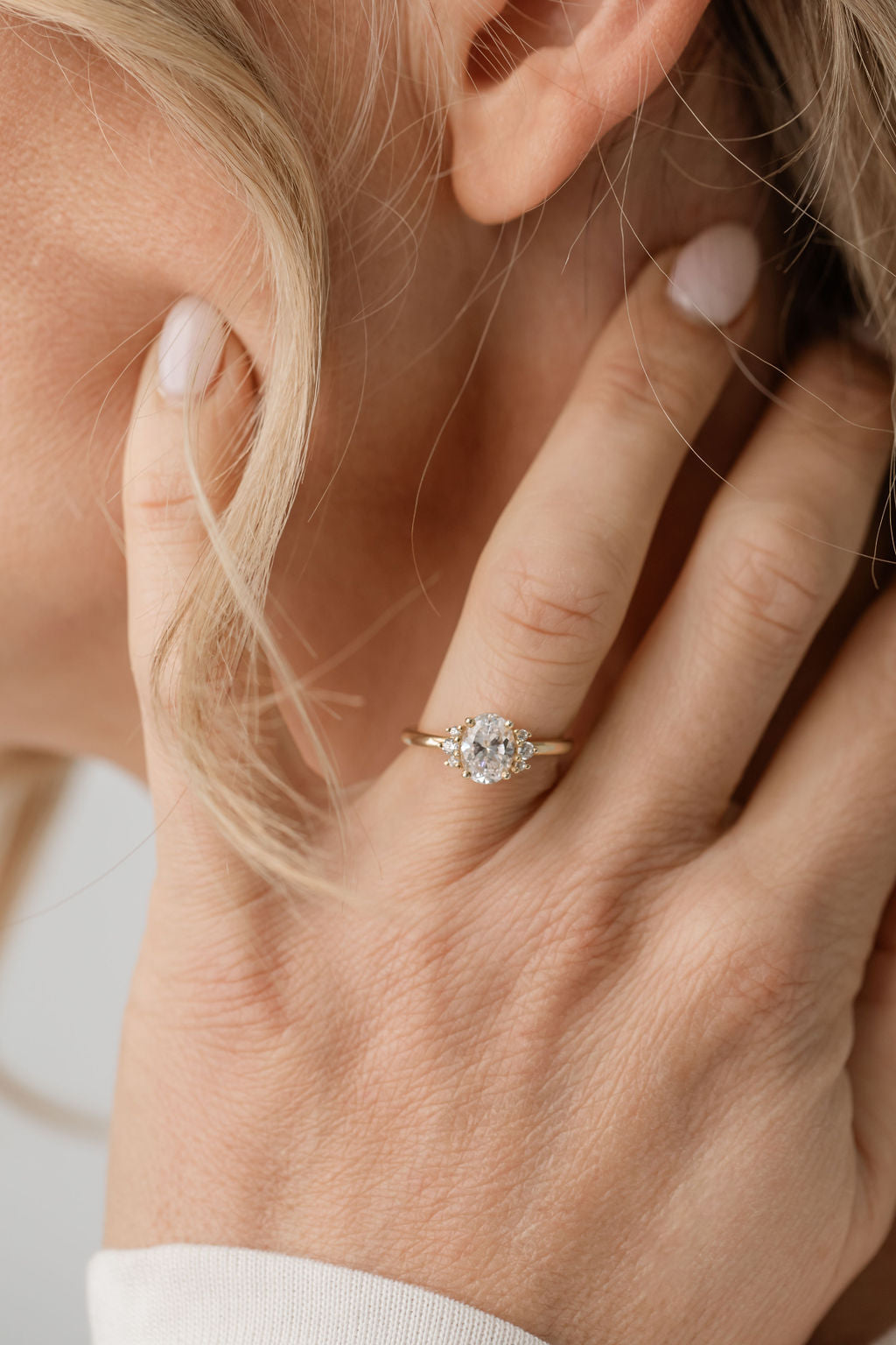 Oval engagement ring with side stones