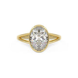 Bezel Set oval engagement with a split shank in yellow gold