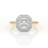 Elongated cushion cut engagement ring with a halo and millgrain detail