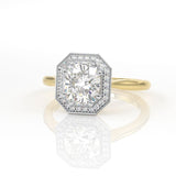 Halo engagement ring with an elongated cushion cut centre stone, diamond halo and millgrain edge