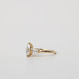 side view of trilogy three stone ring with marquise cut centre stone