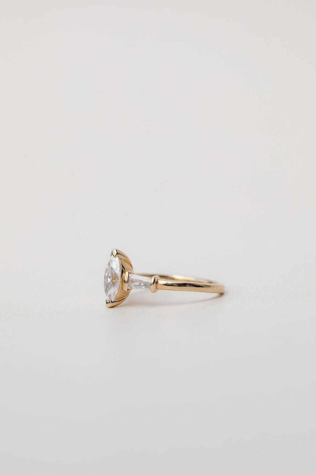 side view of trilogy three stone ring with marquise cut centre stone