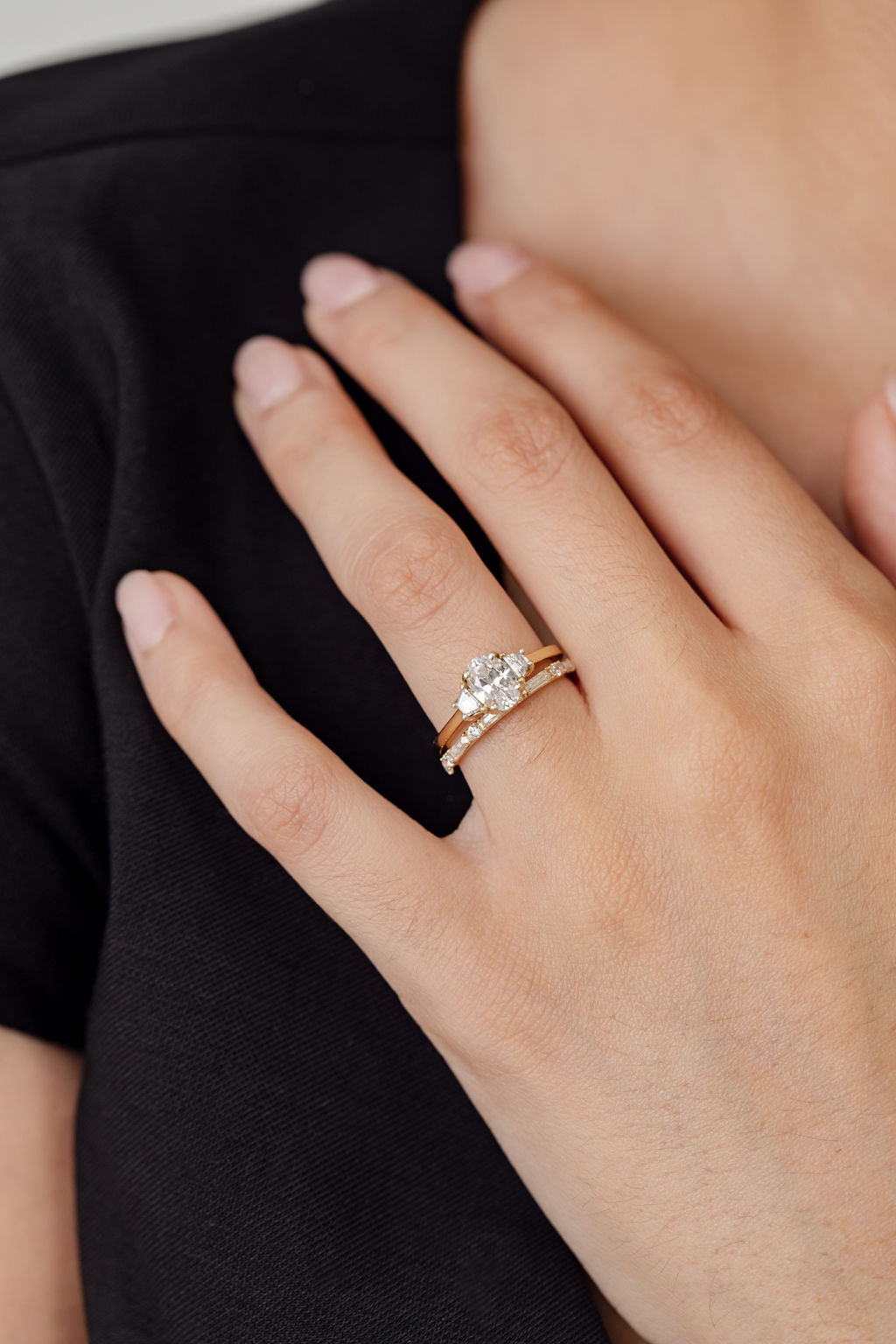 three stone engagement ring with oval centre and diamond wedding ring