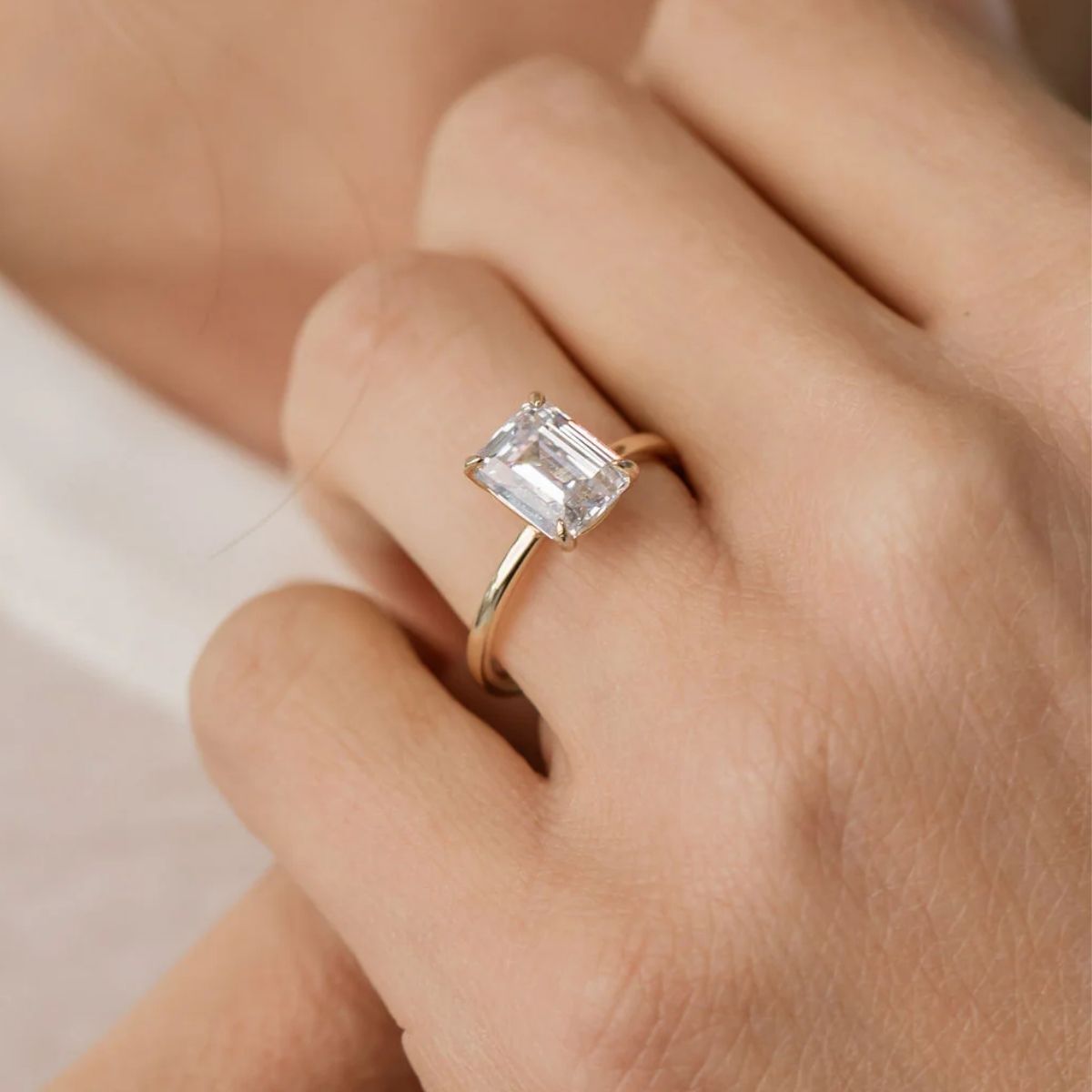 Emerald cut diamond solitaire engagement ring showcasing clean lines and classic elegance