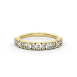 A round diamond sparkly brilliance in a statement diamond ring, set in a gold band with two smaller diamonds alternating. 