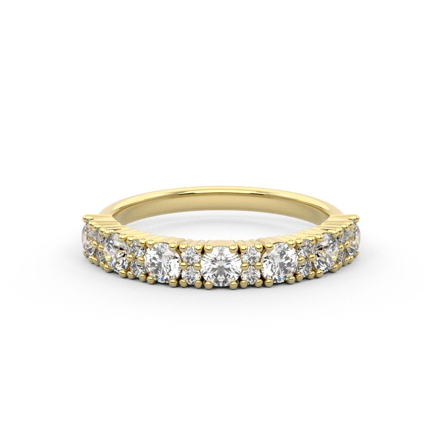 A round diamond sparkly brilliance in a statement diamond ring, set in a gold band with two smaller diamonds alternating. 