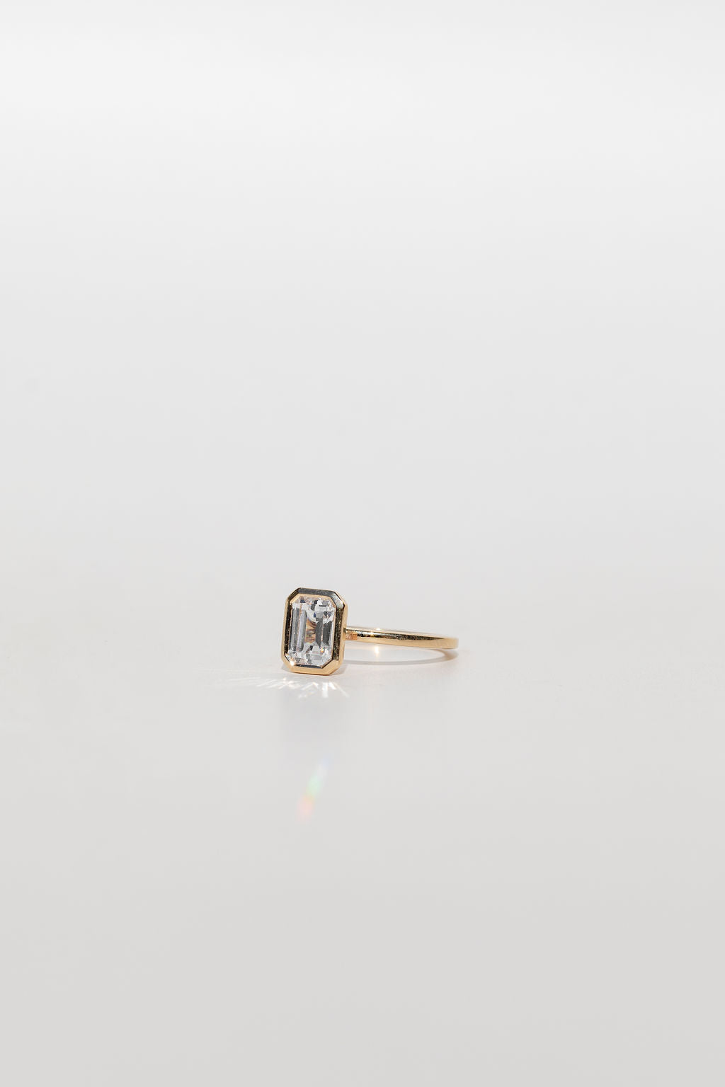 Bezel Set Emerald Cut Diamond Engagement Ring in Yellow Gold