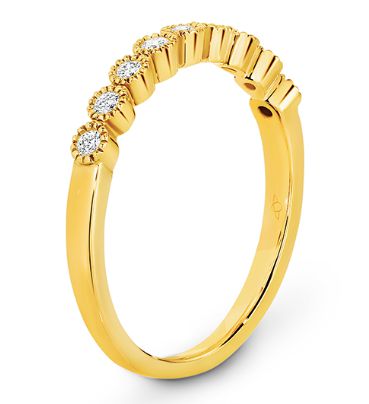 Bezel set diamonds with delicate millgrain edging eternity ring in yellow gold 