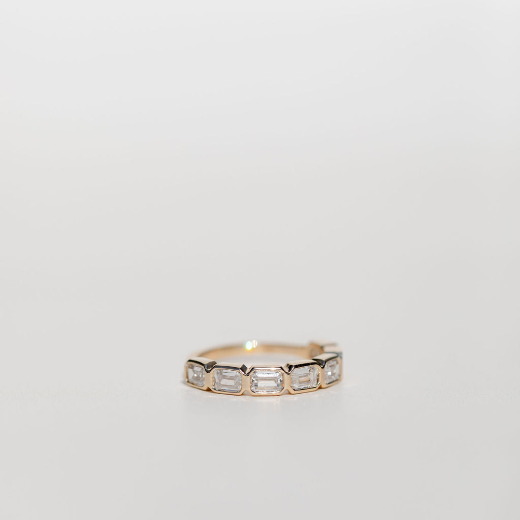 Bezel set emerald cut diamond statement wedding ring