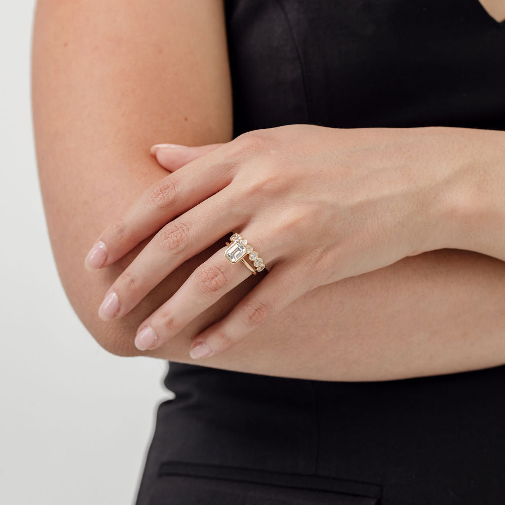 Bezel set emerald cut engagement ring with oval cut bezel set wedding ring