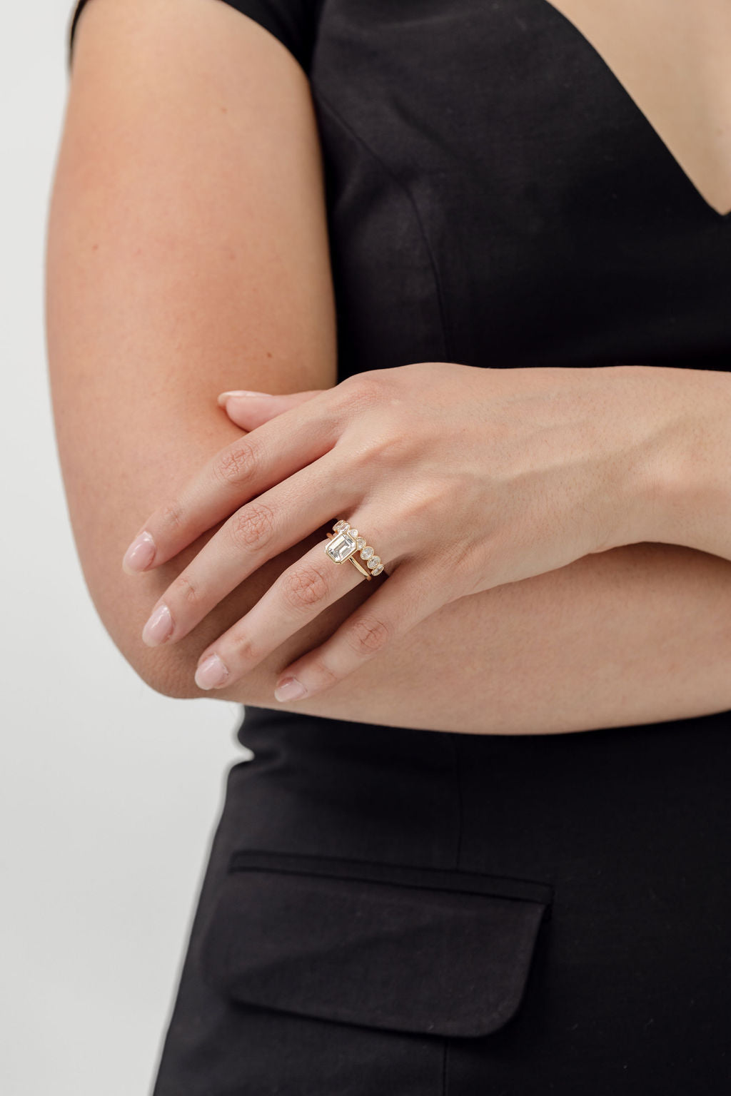 Bezel set emerald cut engagement ring with oval cut bezel set wedding ring
