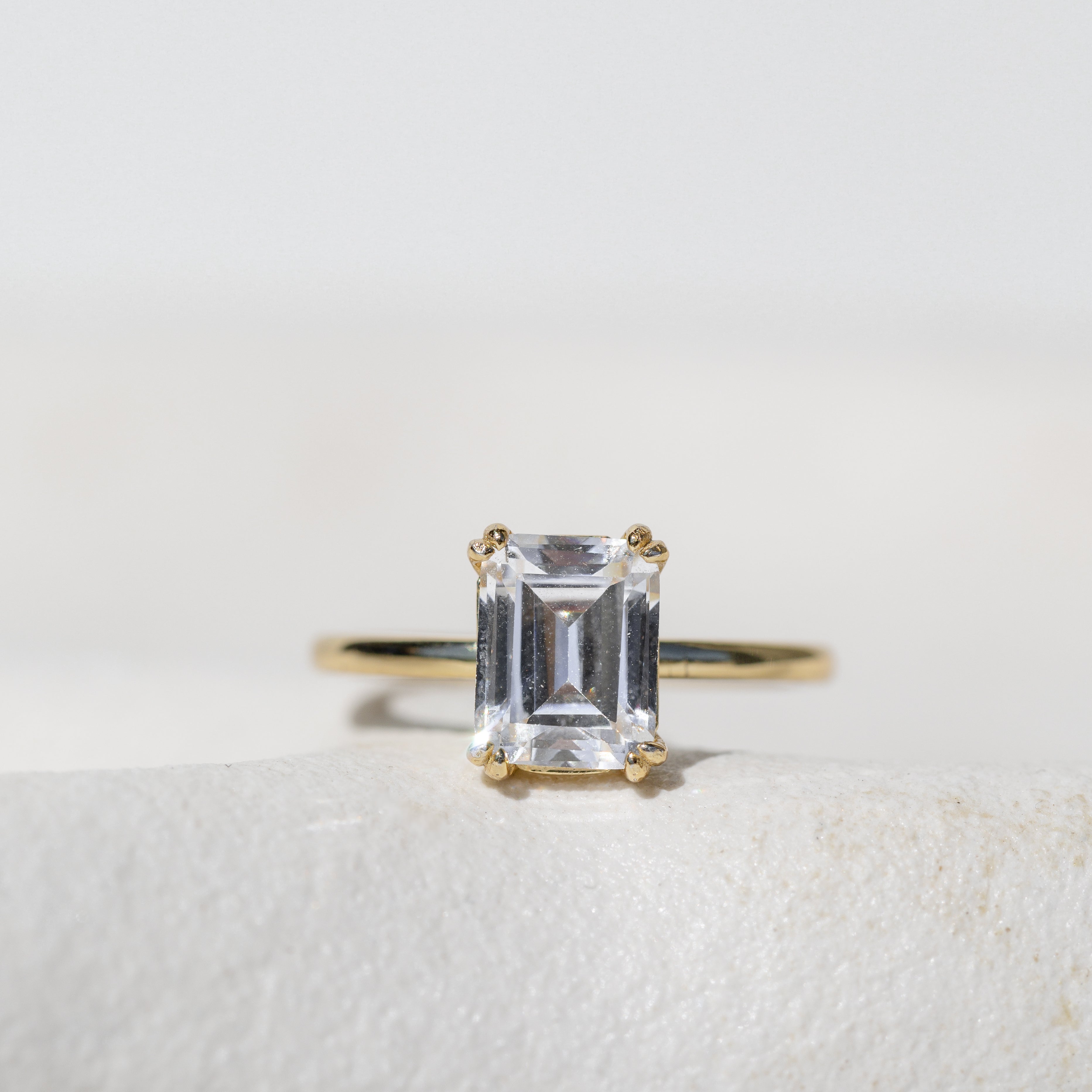 DOUBLE CLAW EMERALD CUT SOLITAIRE ENGAGEMENT RING